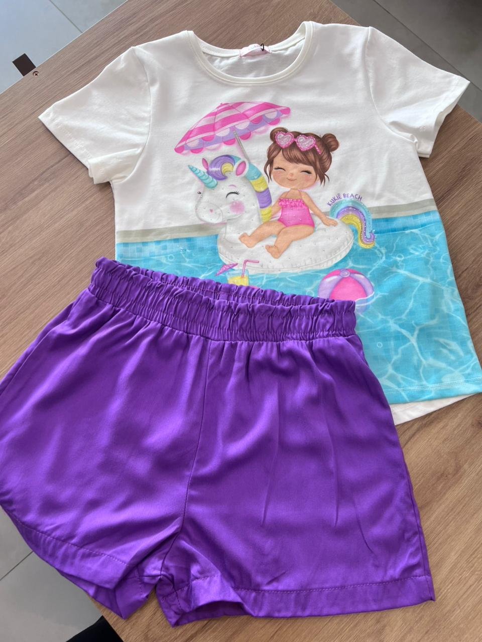 CONJUNTO BLUSA MANGA CURTA PRAIA UNICORNIO E SHORT MENINA KUKIÊ - OFF/ROXO